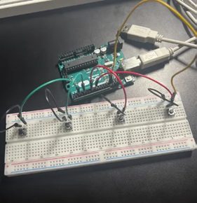 The button interface prototyped on a breadboard, four tactile switches wired back to an Arduino.