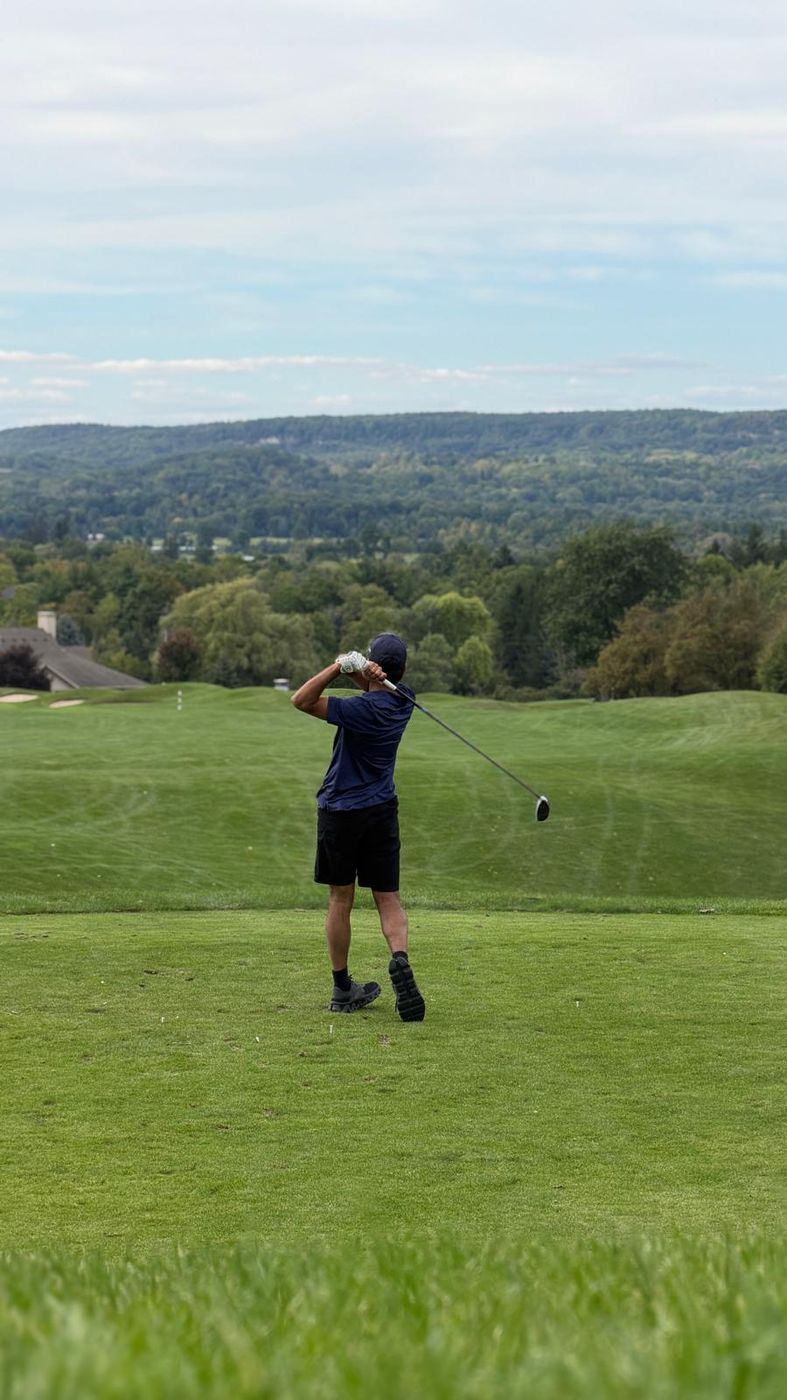 A second tee shot from the same course, club finished high over the shoulder.