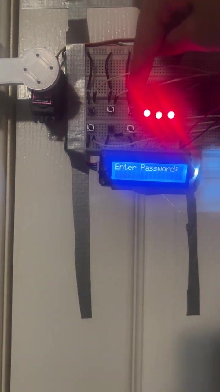 A finger on a pushbutton, three red LEDs lit, the LCD reading Enter Password with masked characters.