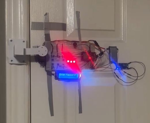 The door lock prototype taped to a door with its LCD lit and a servo latch on the frame.